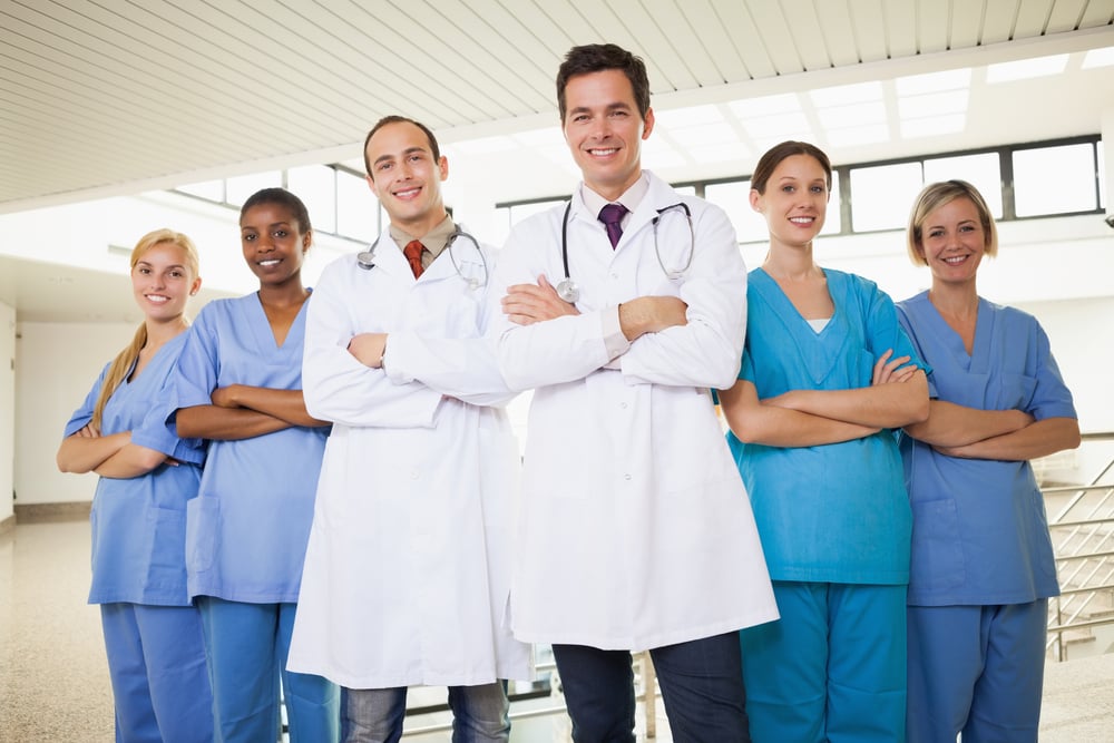 Doctors with nurses with arms crossed in hospital corridor Doctors with nurses with arms crossed in hospital corridor