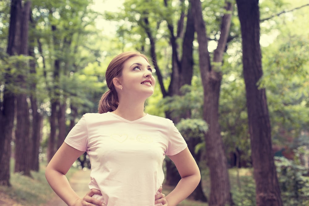 Portrait young attractive smiling fit woman resting after workout sport exercises outdoor looking up enjoying fresh air standing on background park trees. Healthy lifestyle well being wellness concept Portrait young attractive smiling fit woman resting after workout sport exercises outdoor looking up enjoying fresh air standing on background park trees. Healthy lifestyle well being wellness concept